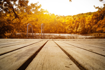 Wooden pier of free space and landscape of autumn lake. 