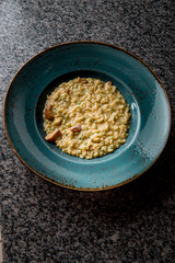 risotto with mushrooms in a green plate