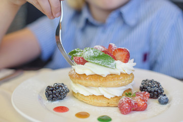 little boy eating dessert in a cafe