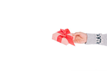 close-up partial view of man in sweater holding gift box isolated on white