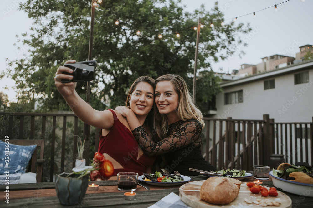 Sticker Lesbian couple taking a selfie