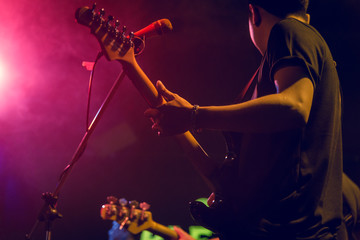 Stage Live performance.Abstract musical background. Musician Playing guitar and concert concept.Live music background.Music festival.Instrument on stage and band