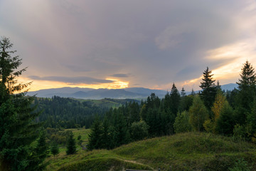 Obraz na płótnie Canvas Sunset against the backdrop of mountains and wildlife. Nature, travel, tourism