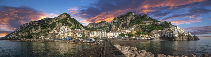 Fototapeta na wymiar Beautiful panorama of Amalfi, the main town of the coast on which it is located taken from the sea. Situated in province of Salerno, in the region of Campania, Italy, on the Gulf of Salerno at sunset