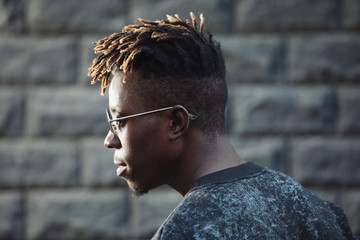 African rapper man with dreadlocks hairstyle wearing modern glasses