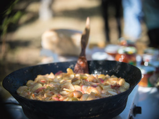 Fried apples in a cast-iron black frying pan