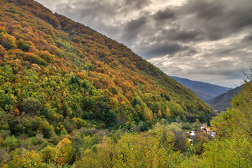 Beautiful landscape view of the mountains of the Rila national park in Bulgaria with vibrant autumn colors in the forest