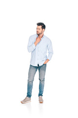 Fototapeta premium full length view of handsome young man standing with hand in pocket and looking away isolated on white