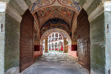 Fototapeta na wymiar Beautiful view of the entrance gate at the Orthodox Rila Monastery, a famous tourist attraction and cultural heritage monument in the Rila Nature Park mountains in Bulgaria