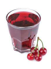 Cherry juice in a glass next to a fresh red cherry on a white isolated background