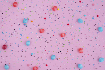 Round blue mint and red candies caramel on pink background.