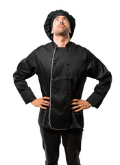 Chef man In black uniform stand and looking up on isolated white background