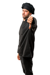 Chef man In black uniform showing thumb down sign with negative expression on isolated white background