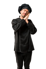 Chef man In black uniform making sleep gesture. Adorable and sweet expression on isolated white background