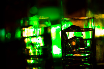 colored lighting of glasses in the night club bar