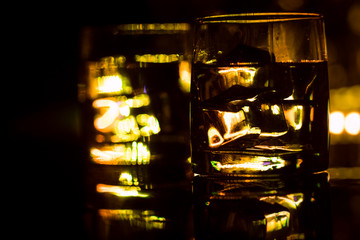 colored lighting of glasses in the night club bar