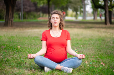 Pregnant woman practicing yoga in nature
