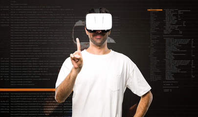 Naklejka premium Man using VR glasses counting one inside the virtual reality mode
