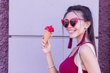 Cherry taste. Positive delighted woman smiling while enjoying her ice cream