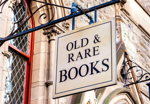 A"Old & Rare Books" sign in front of some victorian architecture
