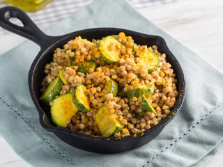 Buckwheat with zucchini and turmeric in cast iron skillet. Easy and healthy lunch for celiac gluten free diet