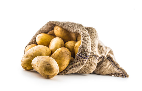 New potatoes in burlap sack isolated on white.