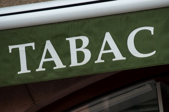 closeup of green tabacco store front with french text tabac, the traduction in english of tobacco