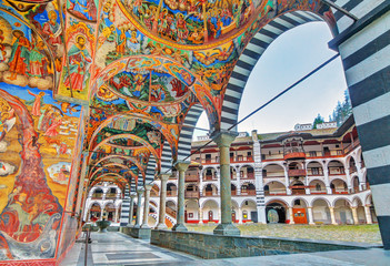 Beautiful view of the vibrant decoration of the Orthodox Rila Monastery, a famous tourist attraction and cultural heritage monument in the Rila Nature Park mountains in Bulgaria - 224138560