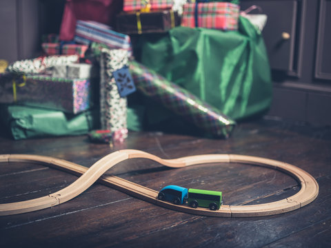 Wooden toy train with christmas tree in background