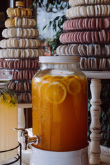 Beautiful sweet table with big cake and macaroon and handmade lemonade