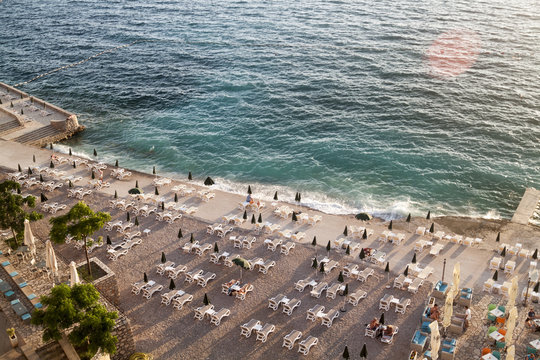 top view of the illuminated by the setting rays of the sun the beach on the Adriatic sea in the town of Dobra Voda, Montenegro