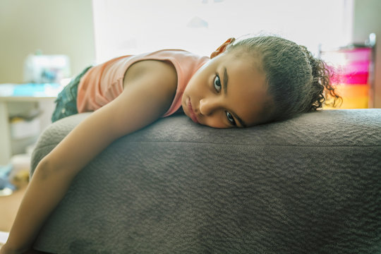 Portrait of girl laying on couch at home