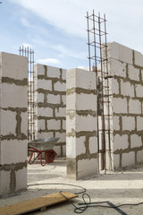 interior of a country house under construction. Site on which the walls are built of gas concrete blocks with wheelbarrow