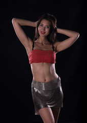 Fototapeta na wymiar sports sexy female fitness model on a black studio background