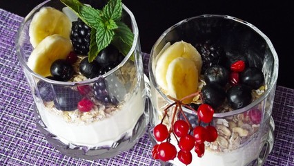 Delicious dessert in a glass.Cereals from the five cereals with yoghurt,banana and fresh berries.