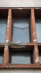 Broken window on a wall of a building.