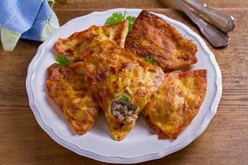 Savory stuffed crepes with meat. Pancakes filled with meat