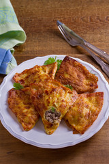 Savory stuffed crepes with meat. Pancakes filled with meat