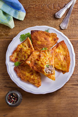 Savory stuffed crepes with meat. Pancakes filled with meat. View from above, top studio shot