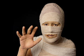 woman wrapped up with bandages as an egyptian mummy as halloween costume