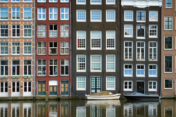 Amsterdam canal Damrak with houses, Netherlands