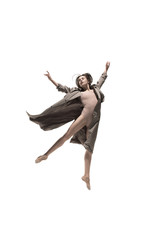 Obraz premium Beautiful slim young female modern jazz contemporary style ballet dancer in silhouette wearing beige long cloak isolated on a white studio background