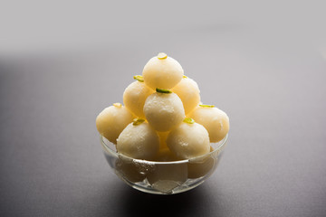 Indian Rasgulla or dry Rosogulla dessert/sweet served in a bowl. selective focus