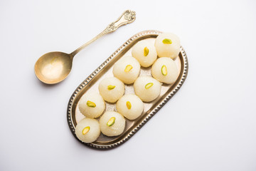 Indian Rasgulla or dry Rosogulla dessert/sweet served in a bowl. selective focus