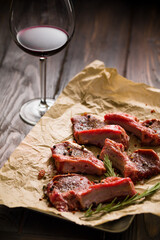 Raw lamb chops on a paper prepared for cooking on a rustic wooden table