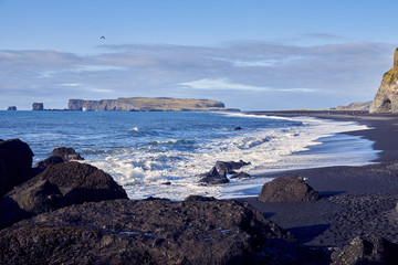 view of the shore with black sand in Iceland