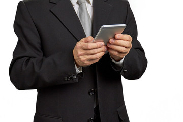 Close up man in black suit with smartphone. Male person in formal wear holding smartphone isolated on white background, cropped image.
