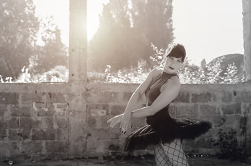 Portrait of adult ballerina dancing outside