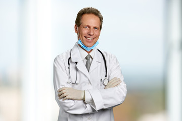 Smiling doctor with ams crossed. Portrait of smiling professional male doctor with folded arms. People, profession, medicine.