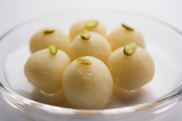 Indian Rasgulla or dry Rosogulla dessert/sweet served in a bowl. selective focus